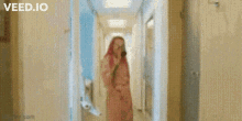 a blurred image of a woman walking down a hallway with the words veed.io at the top