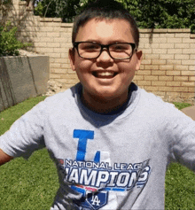 a boy wearing a national league champions shirt