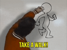 a man draws a cartoon figure with the words take a walk below it