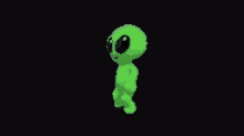 a green alien is standing on a black background .