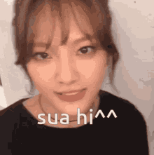 a close up of a woman 's face with the words sua him written above her