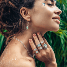 a woman wearing a lot of rings on her fingers