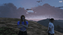 a man and a woman are standing on top of a hill in a video game called evolution