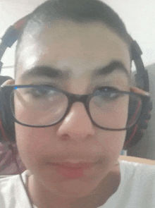 a young boy wearing glasses and headphones is looking at the camera