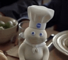 a pillsbury dough boy with a chef hat on