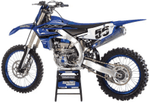 a blue dirt bike has the number 56 on it