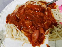 a white plate topped with spaghetti and sauce