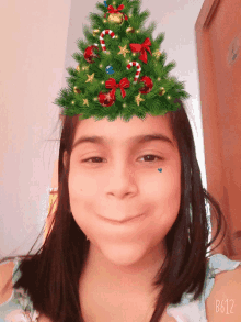 a girl with a christmas tree on her head has b612 on her face