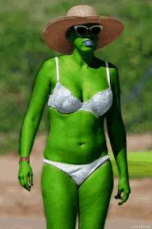 a green woman wearing a white bikini and a hat