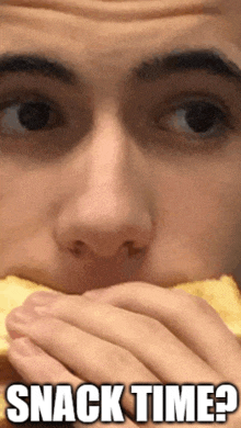 a close up of a man eating a sandwich with the words snack time below him