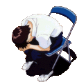 a man is kneeling down next to a chair with his head in his hands .