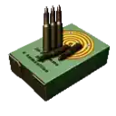 a box of bullets is sitting on top of a green box with a target on it .