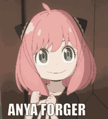 a girl with pink hair and green eyes is smiling with the words anya forger below her