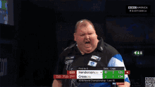 a man in a blue and white shirt stands in front of a scoreboard that says ' henderson ' on it