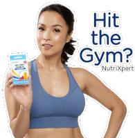 a woman in a blue sports bra is holding a box that says hit the gym on it