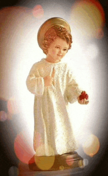 a statue of a child holding a heart in his hand