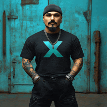 a man wearing a black shirt with a blue x on the front