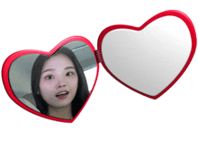 a heart shaped mirror with a woman in it