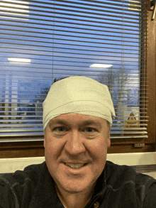 a man with a bandage on his head is smiling