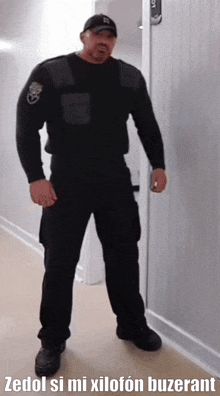 a man in a black uniform is standing in a hallway with the words zedol si mi xilofon buzerant on the bottom