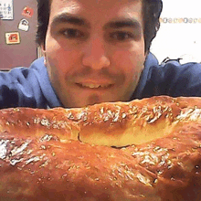 a man is taking a selfie with a loaf of bread .