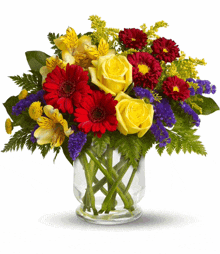 a vase filled with flowers including yellow roses and red daisies