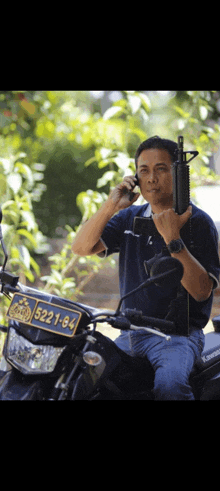 a man is sitting on a motorcycle with a license plate that says 522184