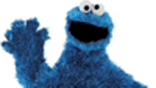 a cookie monster from sesame street is waving his hand .