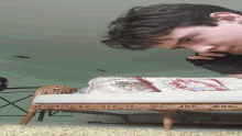 a man talking on a cell phone while looking at a mattress
