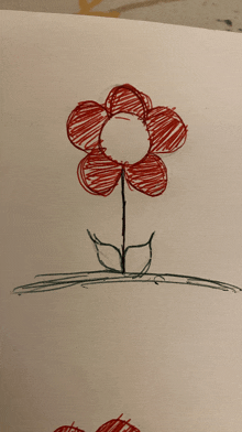 a child 's drawing of a red flower with a green stem