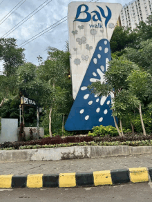 a large blue and white sign that says bay walk on it