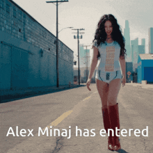 a woman walking down a street with the words alex minaj has entered behind her