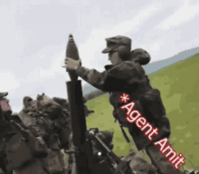 a soldier is holding a cannon with the words agent amit written on the bottom