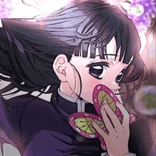 a girl in a purple jacket is holding a pink butterfly in her mouth .