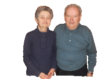 a man and a woman are posing for a picture and the woman is wearing a blue sweater