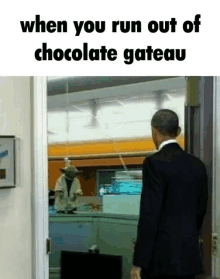 a man in a suit is walking out of a chocolate gateau