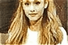 a close up of a woman 's face with long blonde hair .