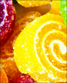 a close up of yellow candy with a white swirl on it