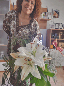 a woman holding a bouquet of white flowers with a butterfly on it