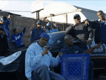 a group of men are posing for a picture and one of them is wearing a dodgers shirt