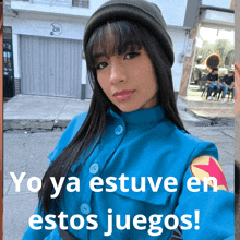 a woman in a blue jacket with the words yo ya estuve en estos juegos