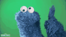 a cookie monster from sesame street is standing in front of a green background with the word bacteria written on it