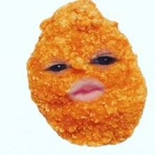 a close up of a chicken nugget with a face on it .