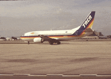 a taca airplane is sitting on the tarmac