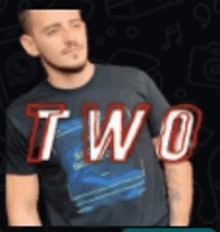 a man wearing a black shirt that says two on it