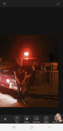 a man in handcuffs stands in front of a police vehicle