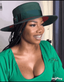 a woman wearing a green hat and a green shirt with the word mc on the front