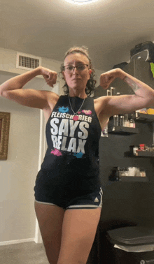 a woman is flexing her muscles and wearing a shirt that says fleisch rieg says relax