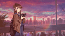 a girl is holding a camera in front of a city