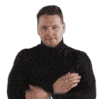 a man in a black turtleneck sweater is clapping his hands